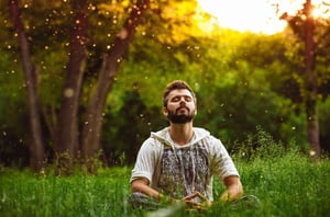man-meditating-on-green-grass-1024x678